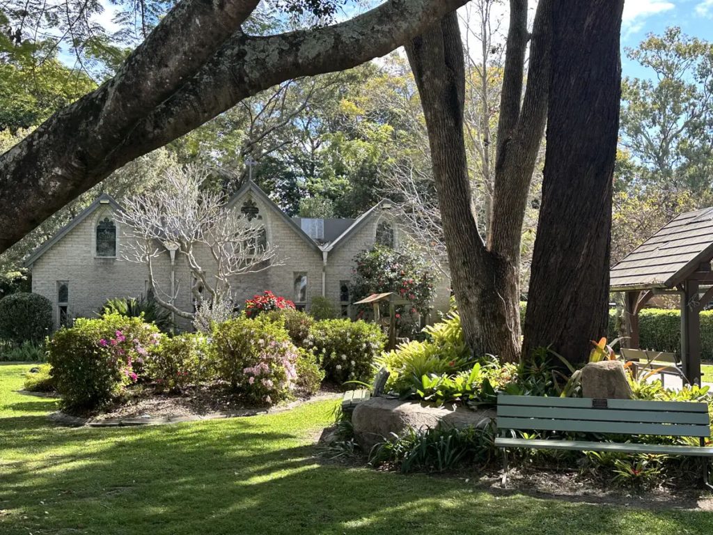 Garden bench and mature trees outside The Abbey Church