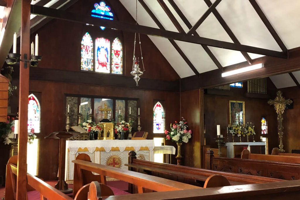 Interior of Abbey Church looking across the nave towards the sanctuary and altar.