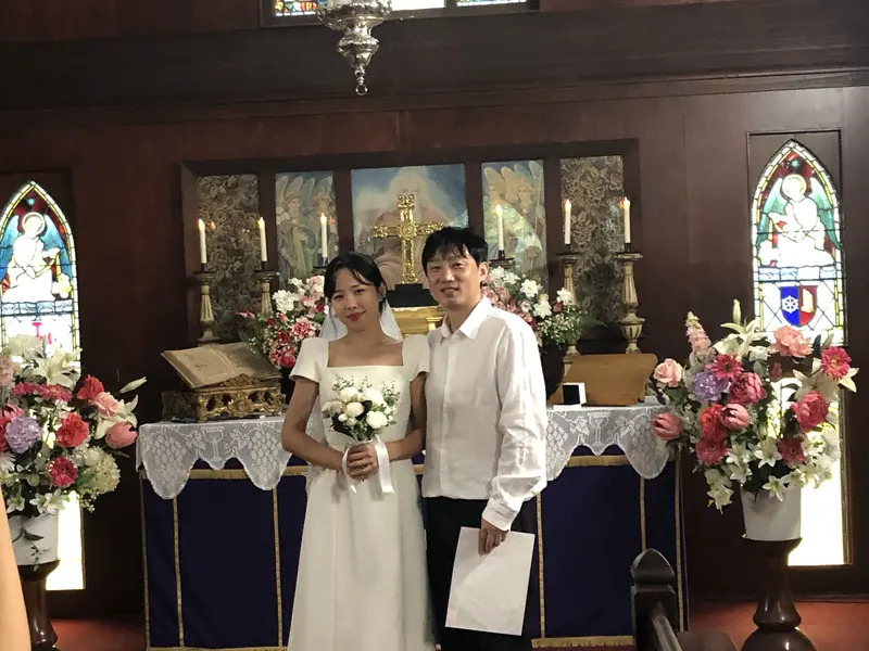 Newly married couple at the altar after a chapel wedding at The Abbey Church