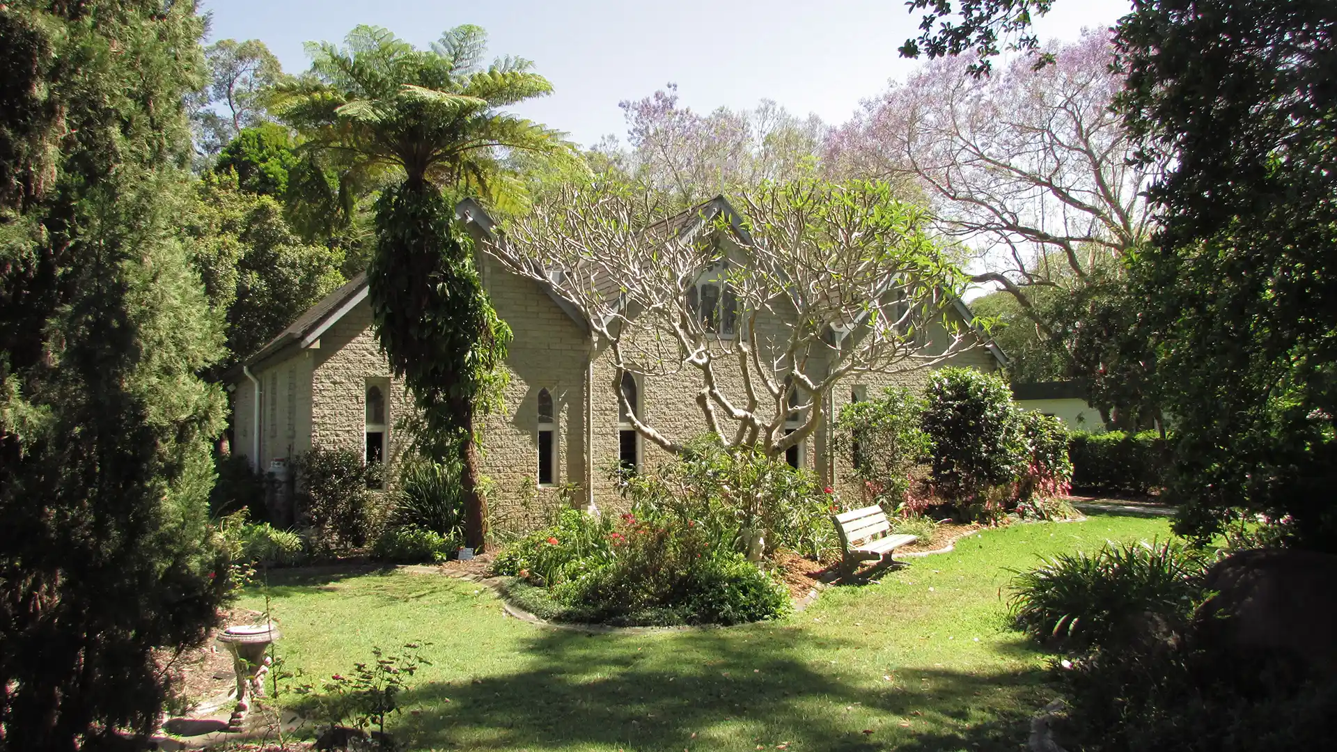 The Abbey Church, Caboolture surrounded by gardens and mature trees