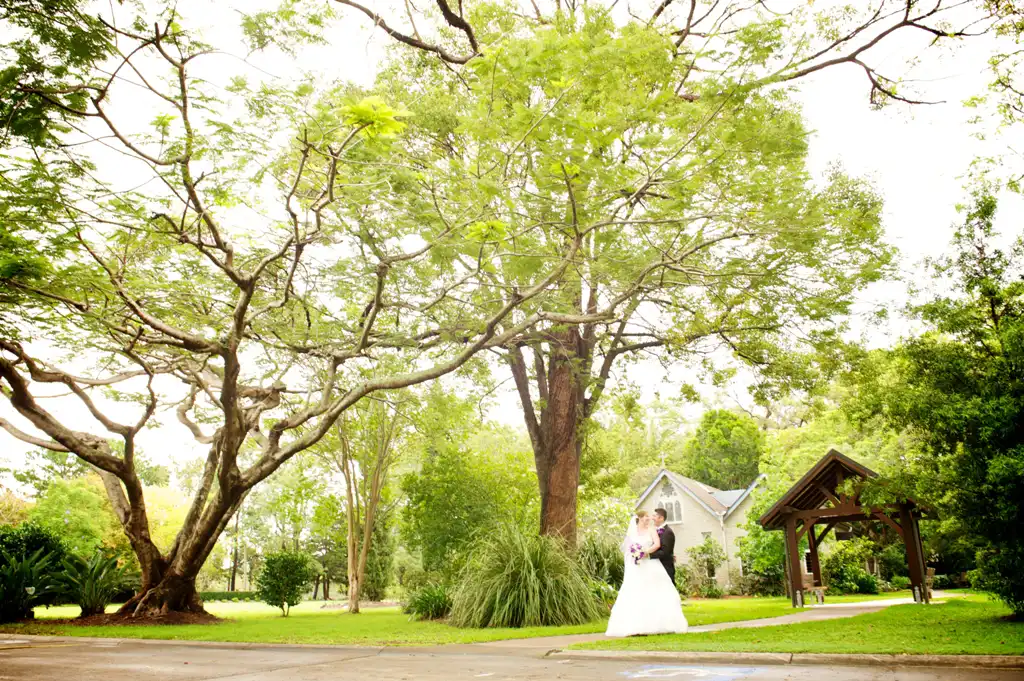 Bride and groom in the gardens after their chapel wedding at The Abbey Church